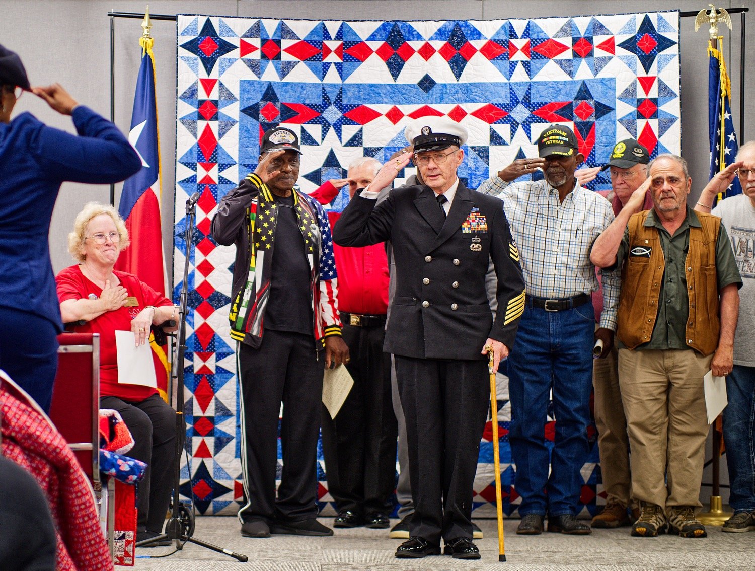 Doc Melott leads veterans in a salute to those who made and presented Quilts of Valor Friday in Quitman. To express his appreciation, "I had to do something," said Melott. [view more veteran appreciation]